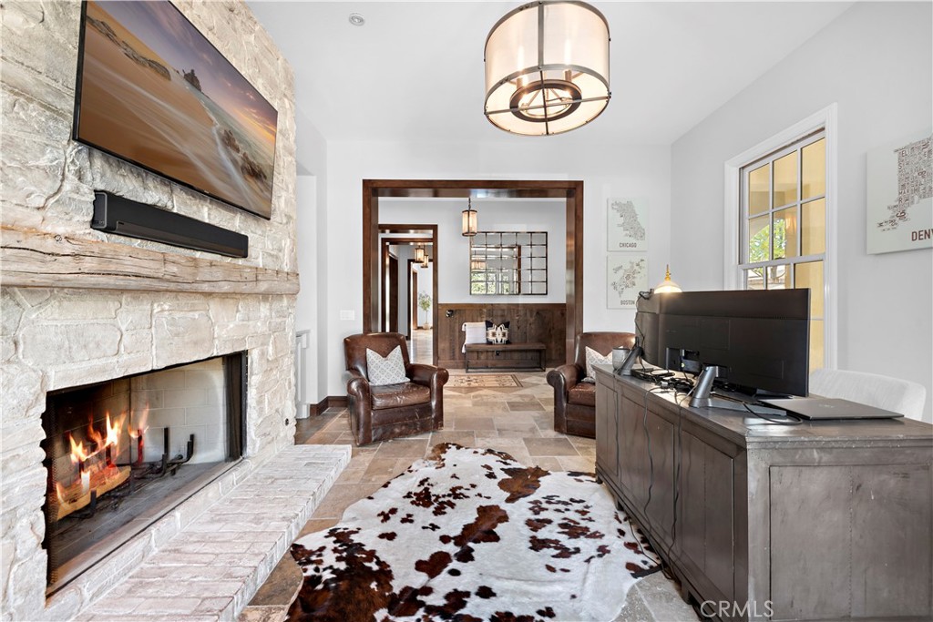 27 Pisano Street Ladera Ranch, CA 92694 - Photo 9 of 71 a living room with furniture a fireplace and a flat screen tv