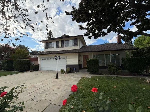 a front view of a house with a yard fire pit and outdoor seating