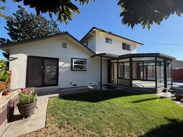 a front view of a house with a yard fire pit and outdoor seating