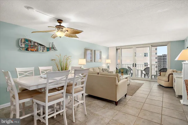 a living room with furniture a chandelier and a window