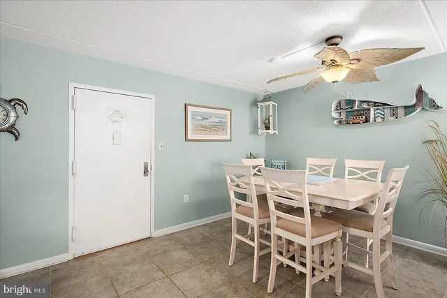 a view of a dining room with furniture and chandelier fan