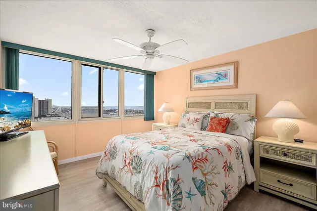 a bedroom with a bed and a large window