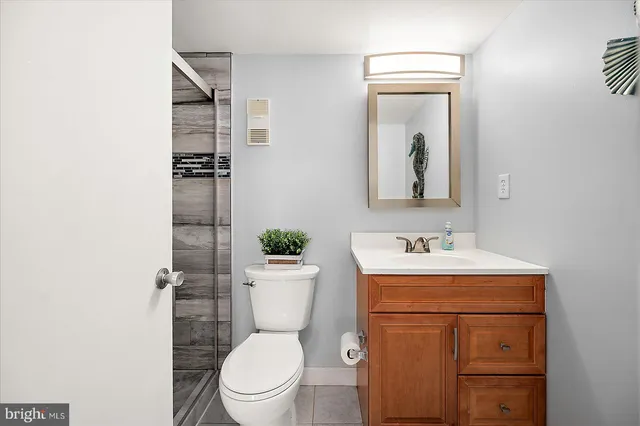 a bathroom with a toilet a sink and mirror