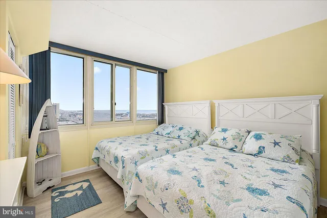 a bedroom with a large bed and a large window