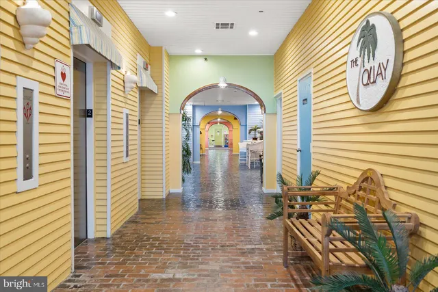 a living room with furniture a rug and a window