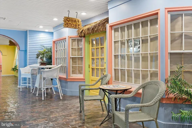 a view of gym equipment with a table and chairs