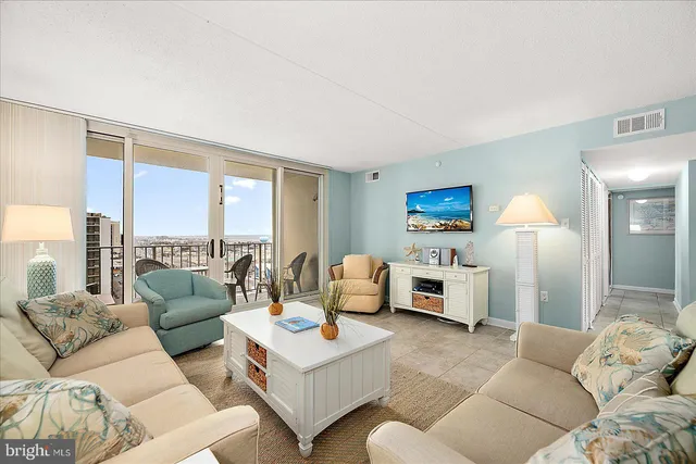 a living room with furniture fireplace and a large window