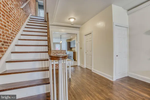 a view of a hallway with wooden floor and entryway
