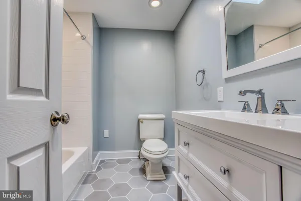 a bathroom with a sink a toilet a vanity and mirror