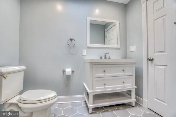 a bathroom with a sink toilet and a mirror