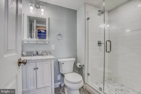 a bathroom with a toilet sink and shower