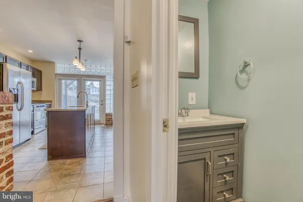 a spacious bathroom with a granite countertop sink a mirror and a vanity