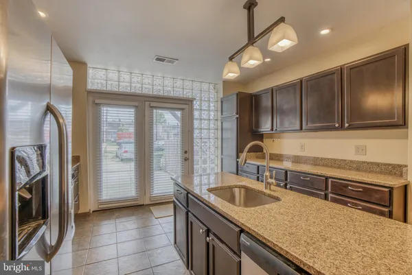 a kitchen with a sink a stove and cabinets
