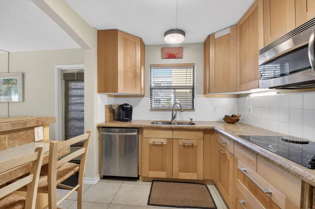 a kitchen with a sink cabinets and window