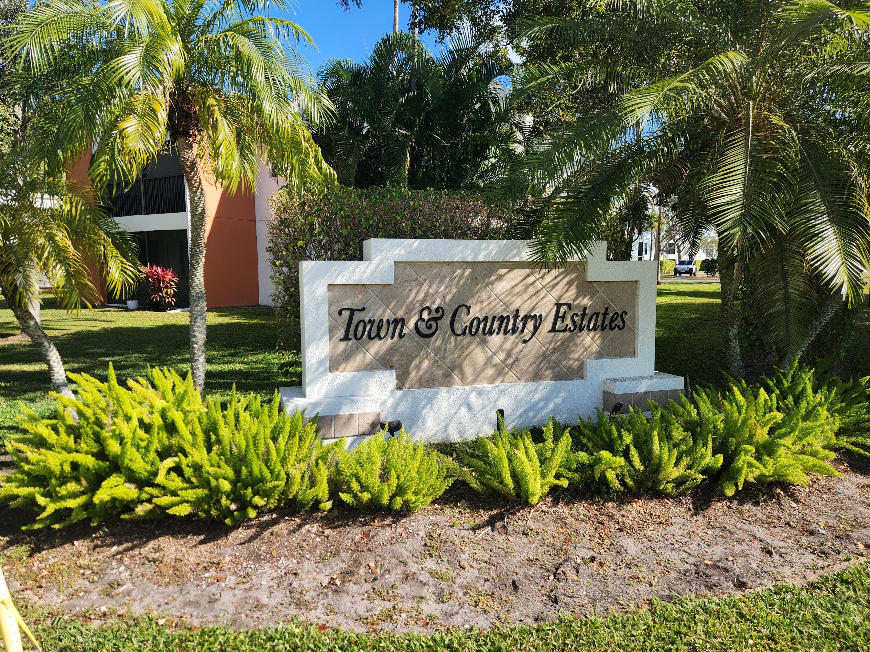 501 Dotterel Road, Unit 26B Delray Beach, FL 33444 - Photo 40 of 48 a sign that is in front of flowers
