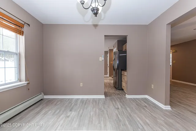 a front view of a house with a yard covered with snow