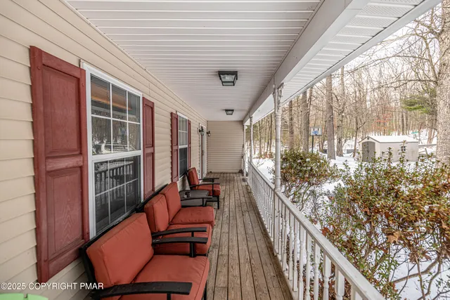 a view of a kitchen with stainless steel appliances granite countertop a refrigerator a sink and wooden cabinets