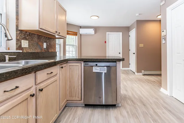 a view of staircase with wooden floor and white walls