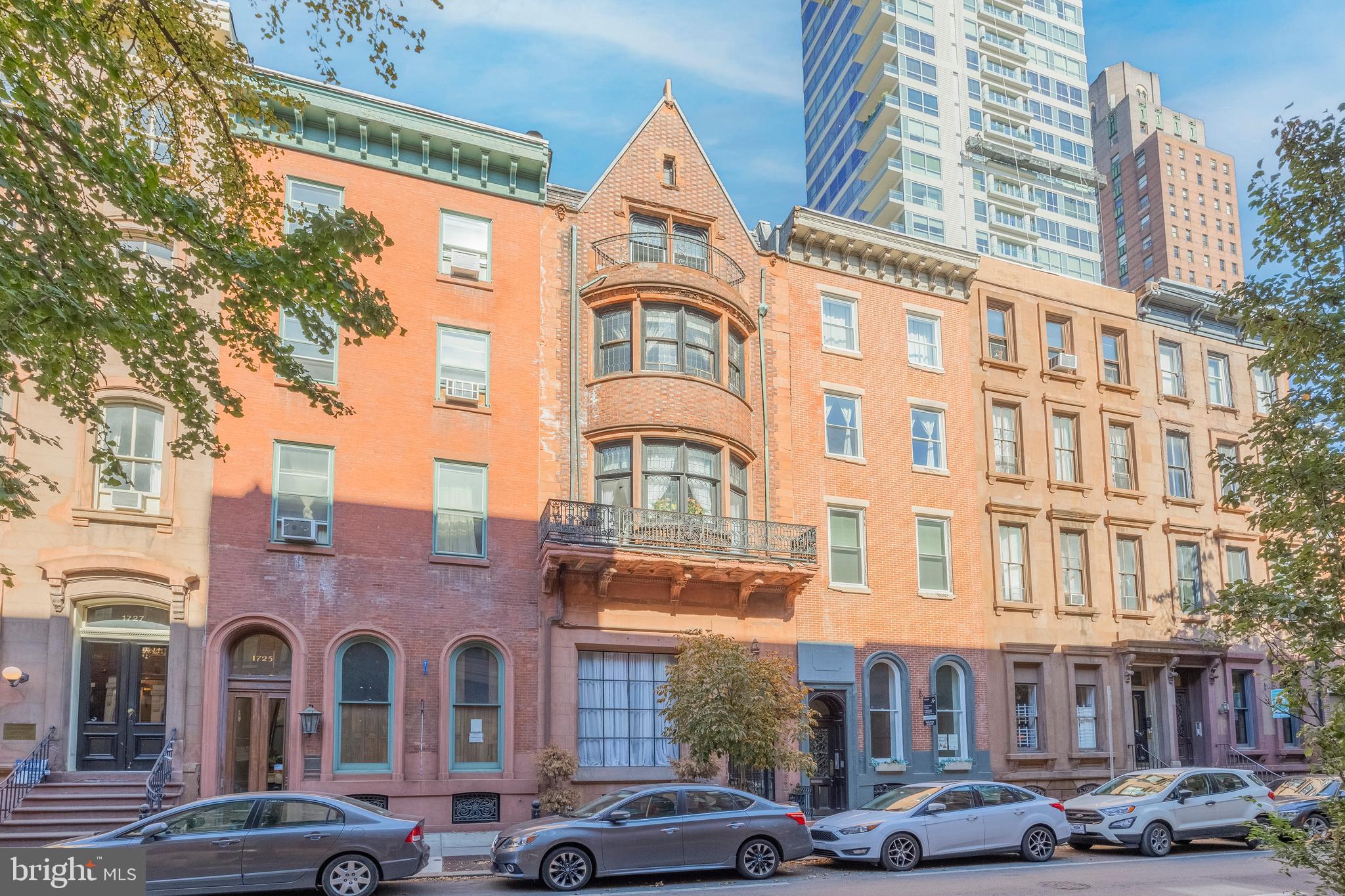 1723 Spruce Street Philadelphia, PA 19103 - Photo 1 of 24 a front view of a building with lot of cars and trees