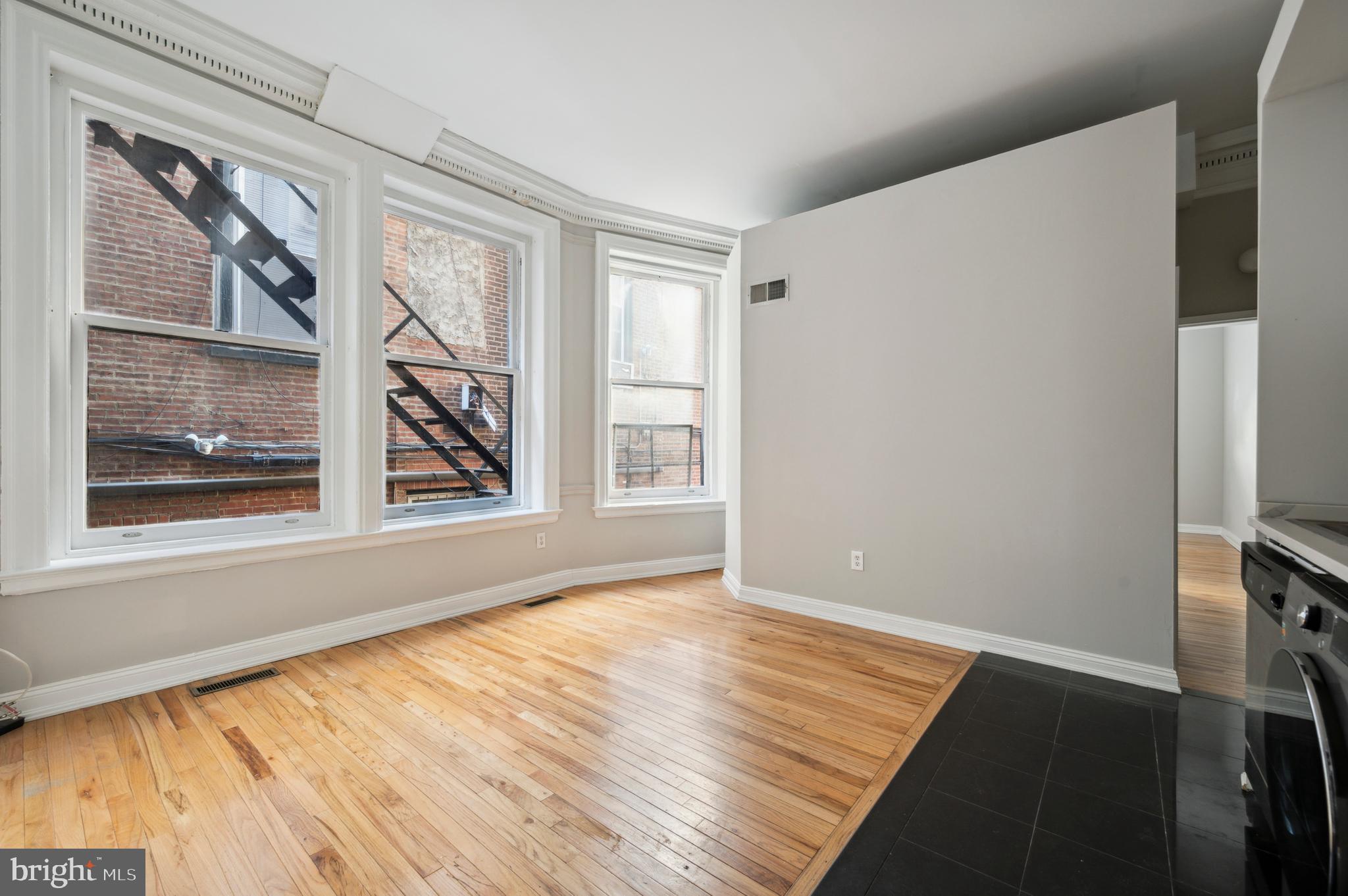1723 Spruce Street Philadelphia, PA 19103 - Photo 11 of 24 a view of an empty room with wooden floor and a window