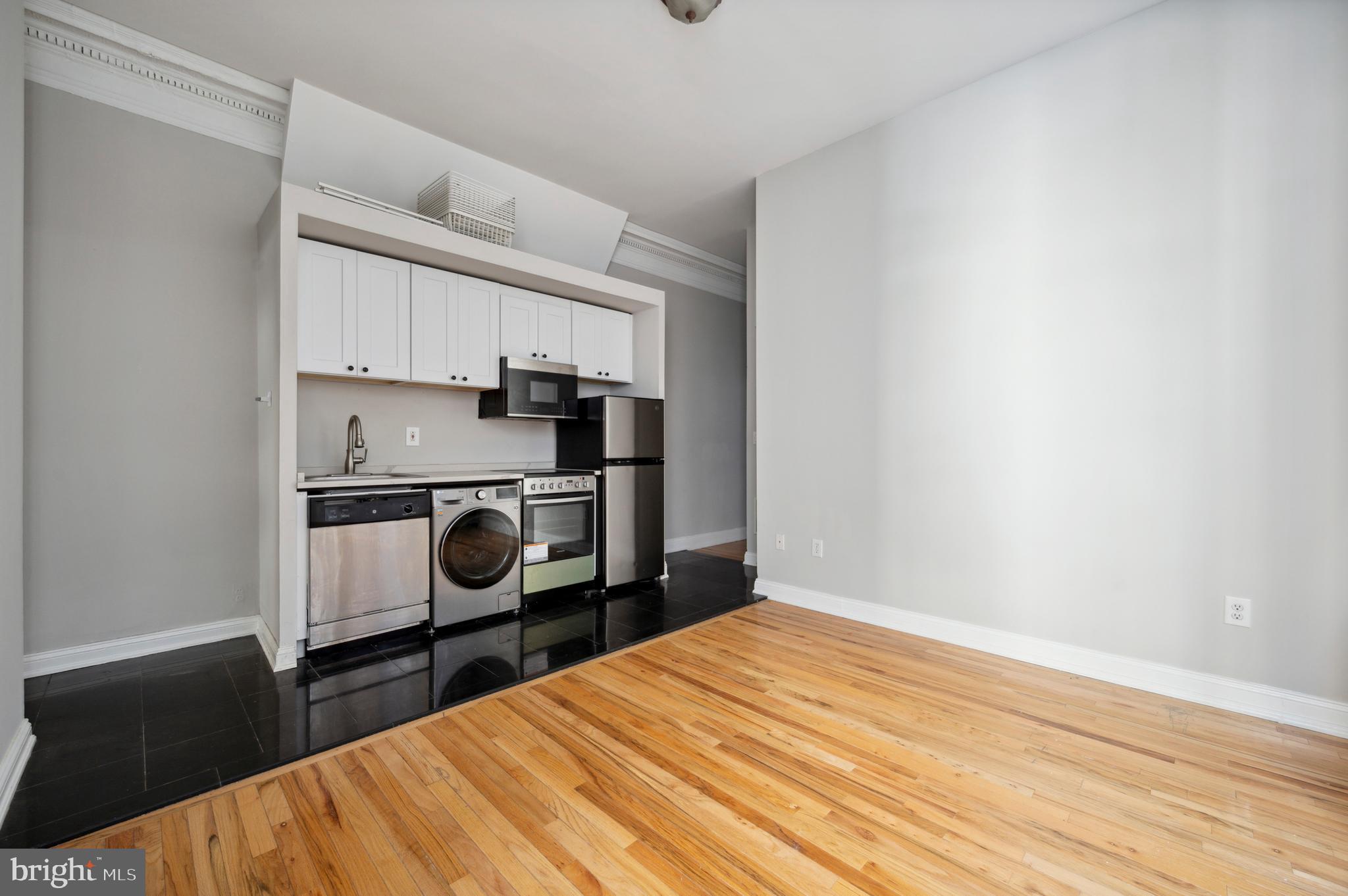 1723 Spruce Street Philadelphia, PA 19103 - Photo 13 of 24 a bedroom with a bed and a cabinets