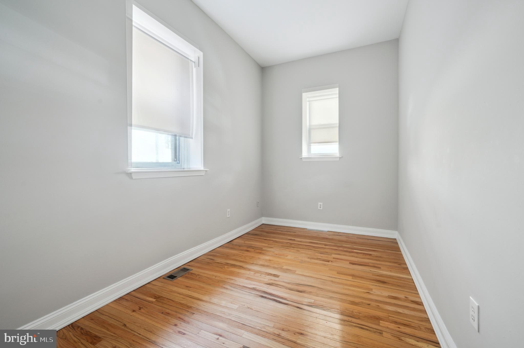 1723 Spruce Street Philadelphia, PA 19103 - Photo 14 of 24 an empty room with wooden floor and windows