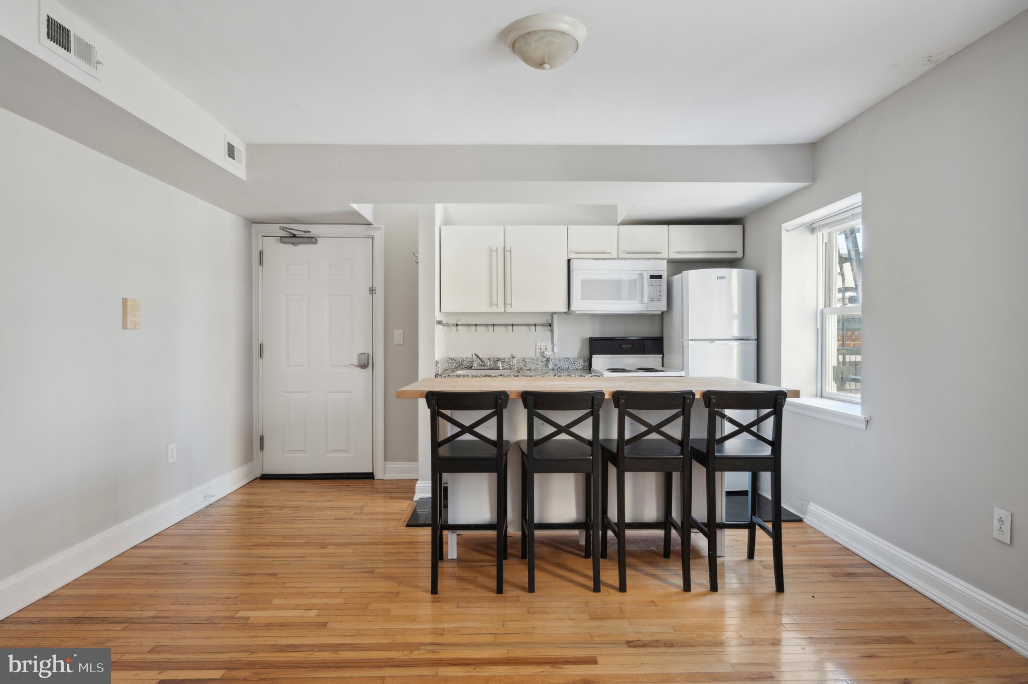 1723 Spruce Street Philadelphia, PA 19103 - Photo 18 of 24 a kitchen with a table and chairs in it
