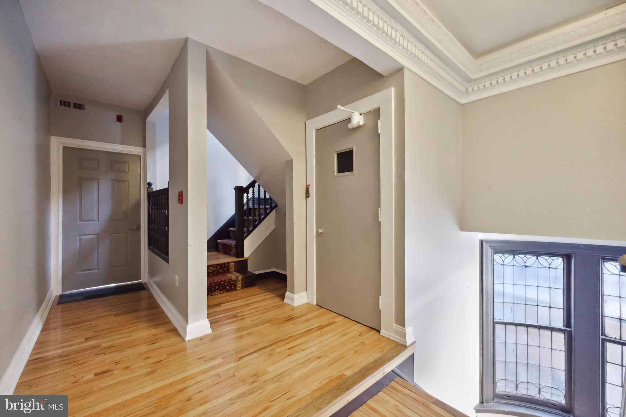 1723 Spruce Street Philadelphia, PA 19103 - Photo 6 of 24 a view of a livingroom with wooden floor and stairs