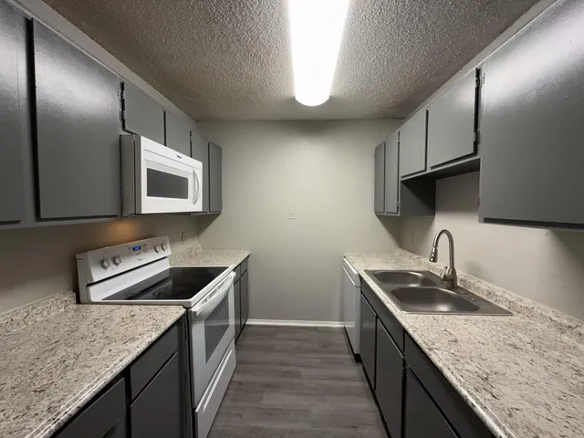 a stove top oven sitting inside of a kitchen