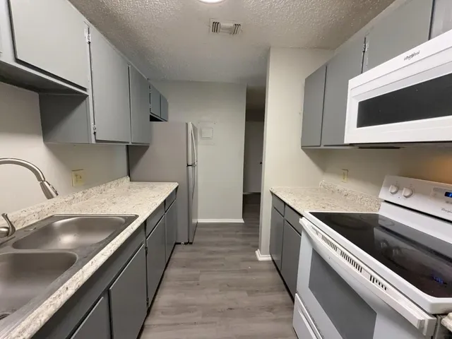 a kitchen with stainless steel appliances a refrigerator and a sink