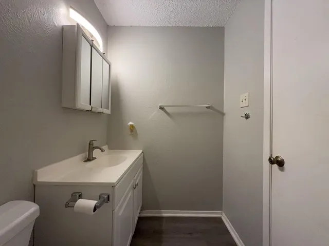 a bathroom with a toilet sink and mirror