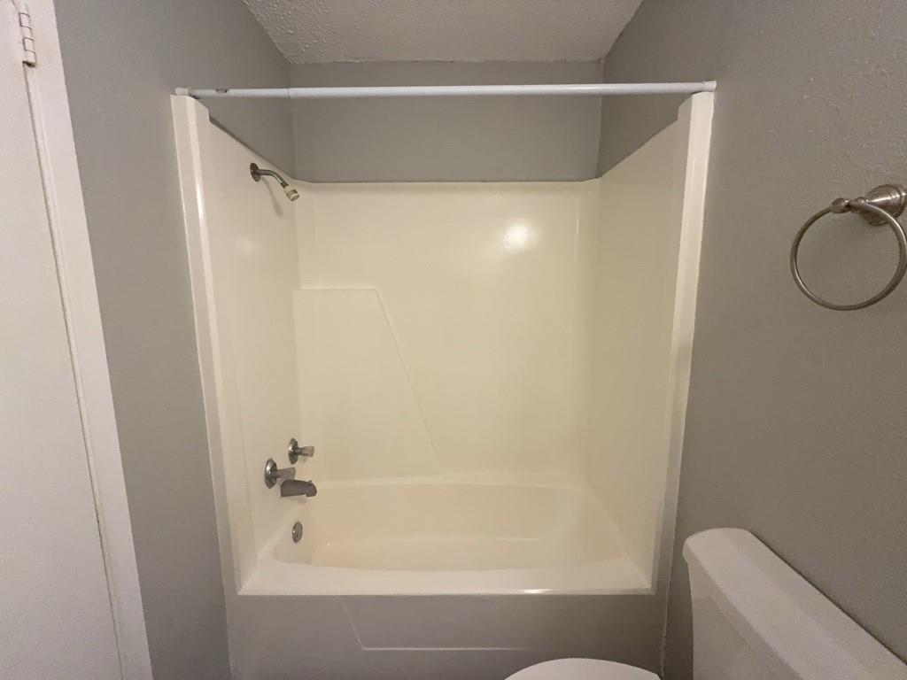 219 Fry Street, Unit 6 Denton, TX 76201 - Photo 22 of 29 a bathroom with a shower and a tub