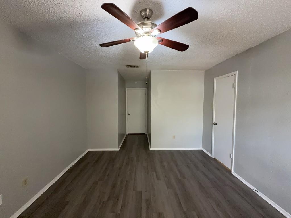 219 Fry Street, Unit 6 Denton, TX 76201 - Photo 26 of 29 a view of an empty room with wooden floor