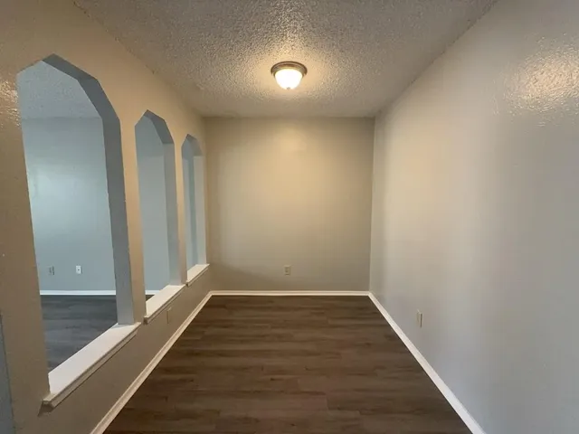 a view of hallway with wooden floor