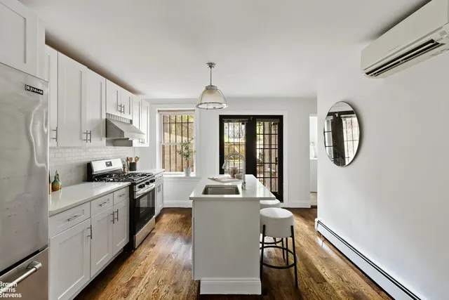 a kitchen with a table chairs refrigerator and cabinets
