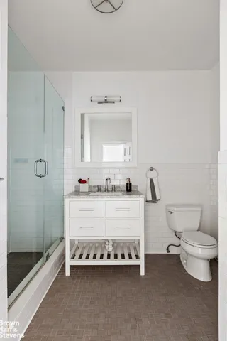 a bathroom with a white tub shower and vanity