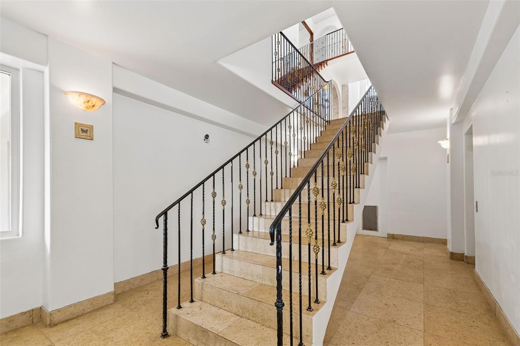 2811 Sunset Way St. Pete Beach, FL 33706 - Photo 17 of 97 a view of a hallway with wooden floor and entryway