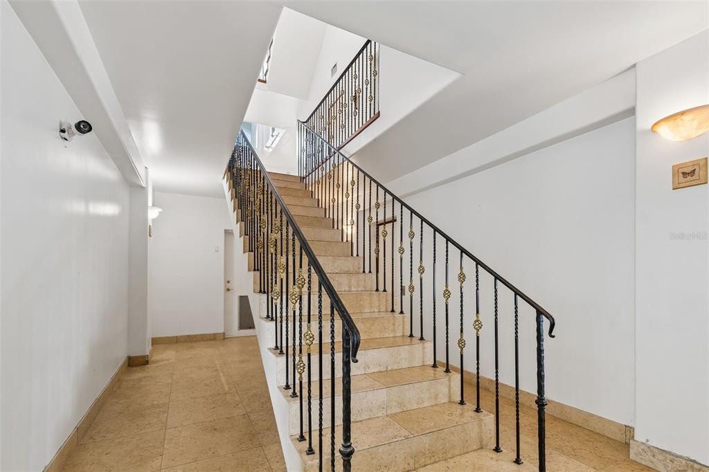 2811 Sunset Way St. Pete Beach, FL 33706 - Photo 18 of 97 a view of staircase with railing and white walls