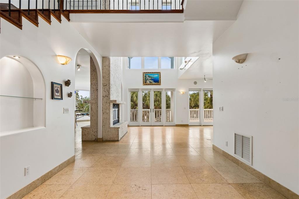 2811 Sunset Way St. Pete Beach, FL 33706 - Photo 20 of 97 a view of an entryway with a floor to ceiling window and a kitchen