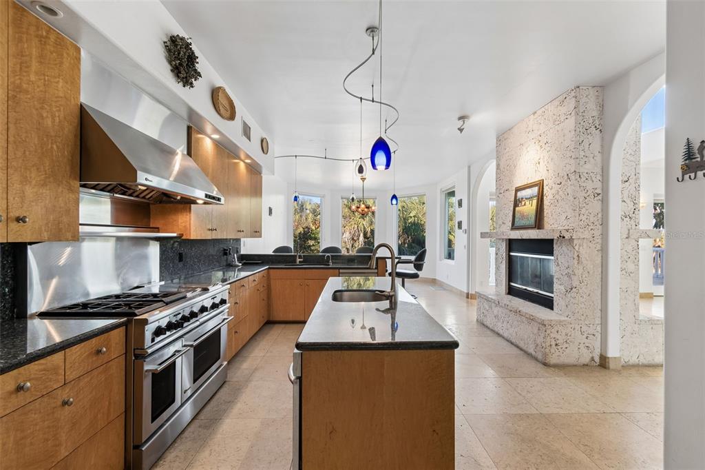 2811 Sunset Way St. Pete Beach, FL 33706 - Photo 26 of 97 a kitchen with stainless steel appliances granite countertop a sink a stove and a refrigerator