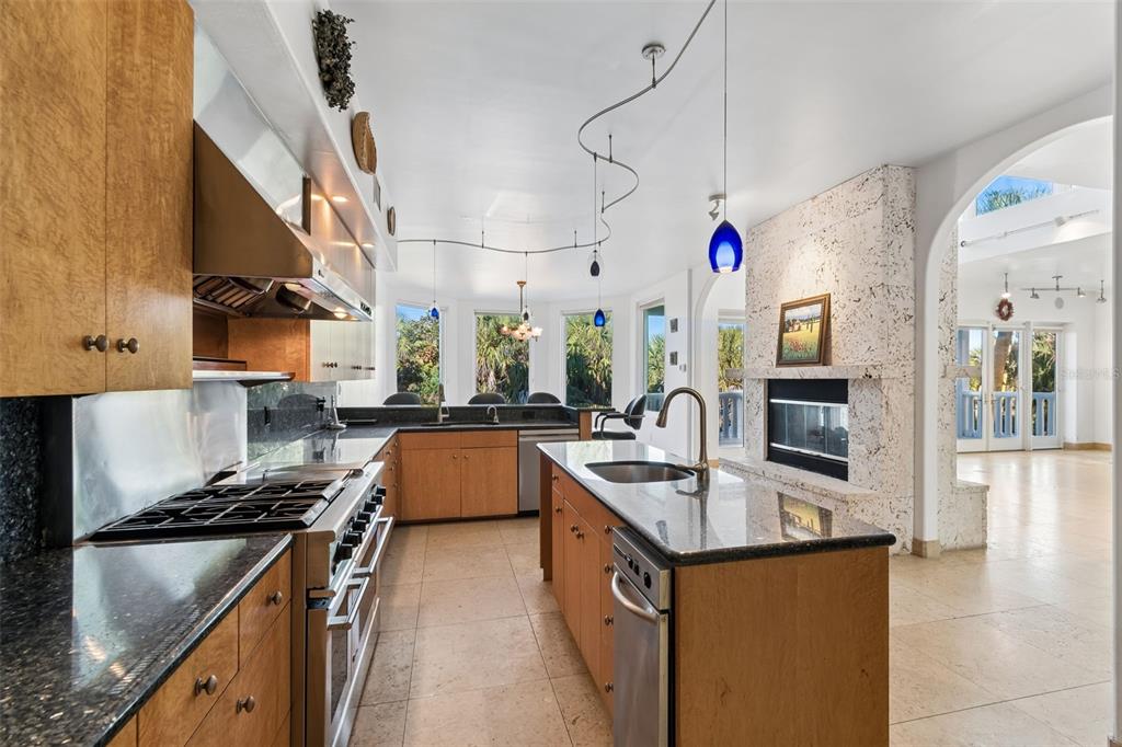 2811 Sunset Way St. Pete Beach, FL 33706 - Photo 27 of 97 a kitchen with stainless steel appliances granite countertop a sink a stove and a refrigerator
