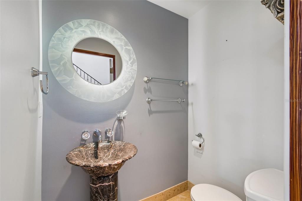 2811 Sunset Way St. Pete Beach, FL 33706 - Photo 43 of 97 a bathroom with a toilet sink and mirror