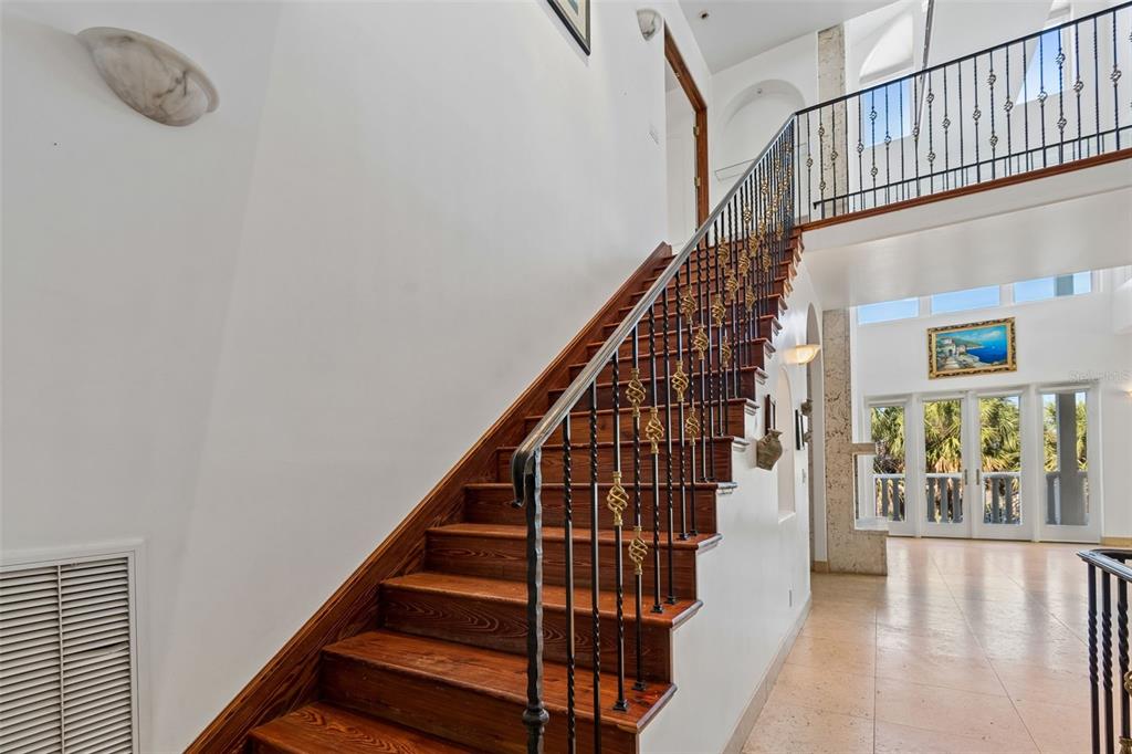 2811 Sunset Way St. Pete Beach, FL 33706 - Photo 44 of 97 a view of staircase with wooden floor and white walls