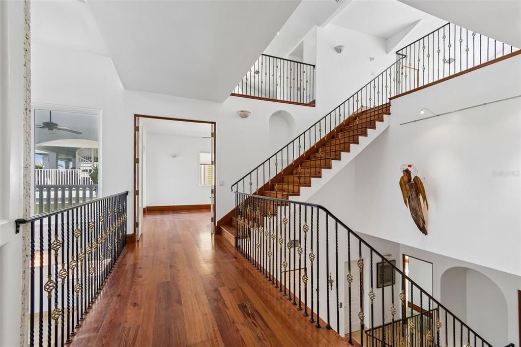2811 Sunset Way St. Pete Beach, FL 33706 - Photo 45 of 97 a view of staircase with wooden floor and white walls