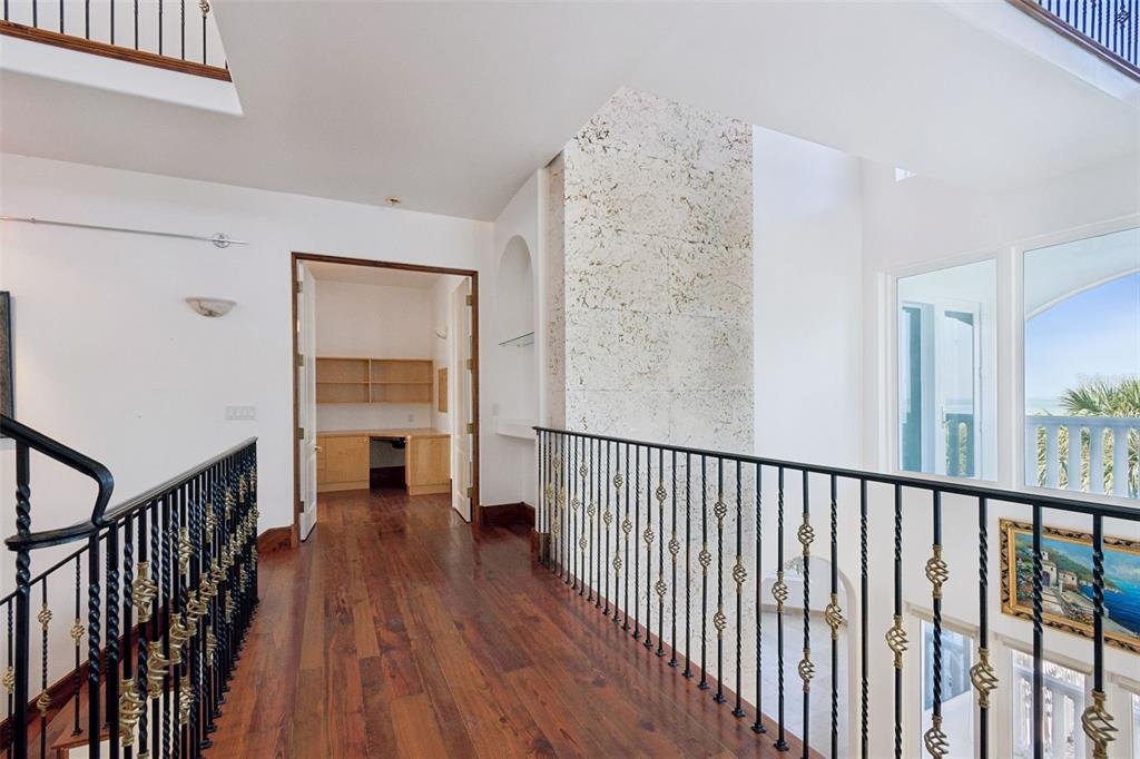 2811 Sunset Way St. Pete Beach, FL 33706 - Photo 47 of 97 a view of a hallway with wooden floor and staircase