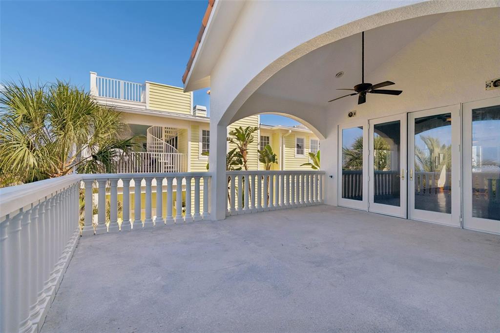 2811 Sunset Way St. Pete Beach, FL 33706 - Photo 61 of 97 a view of a balcony with a ceiling fan