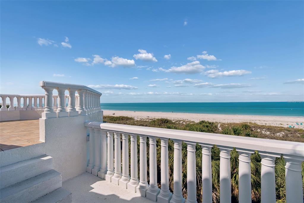 2811 Sunset Way St. Pete Beach, FL 33706 - Photo 77 of 97 a view of a balcony with wooden floor and fence