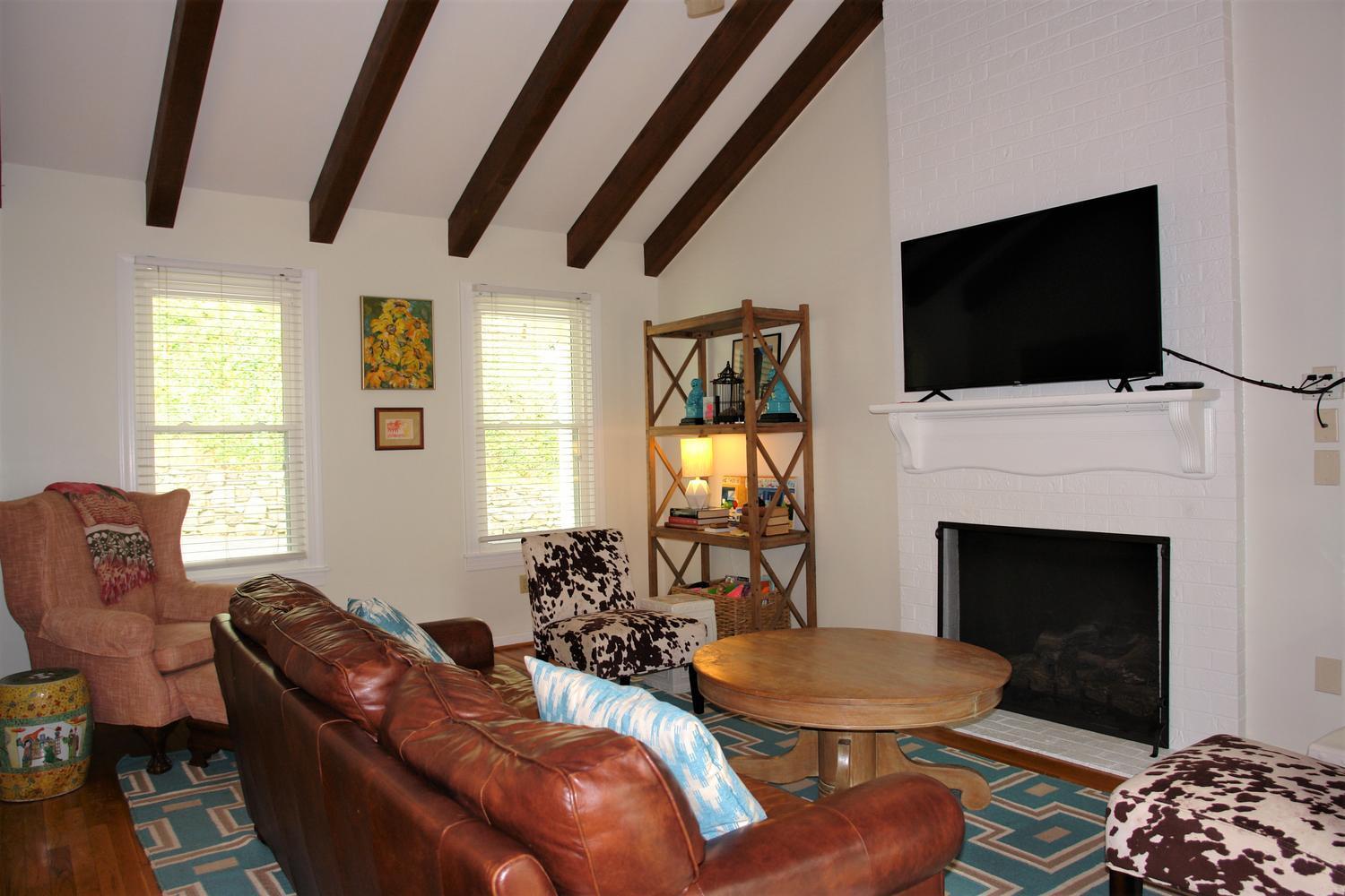 219 Darwin Road Southwest Roanoke, VA 24014 - Photo 18 of 58 a living room with furniture a flat screen tv and a fireplace