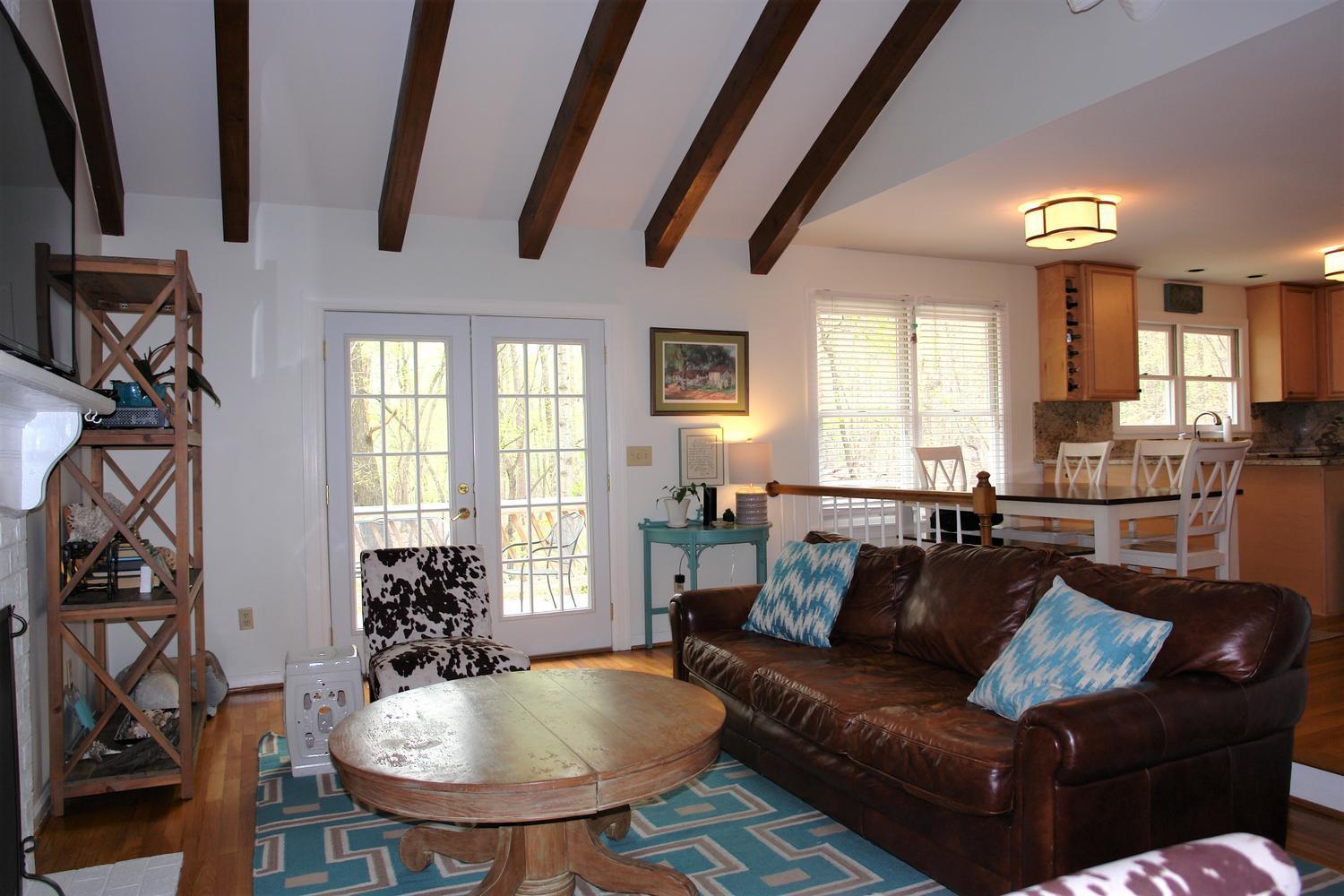 219 Darwin Road Southwest Roanoke, VA 24014 - Photo 19 of 58 a living room with furniture a dining table and a flat screen tv