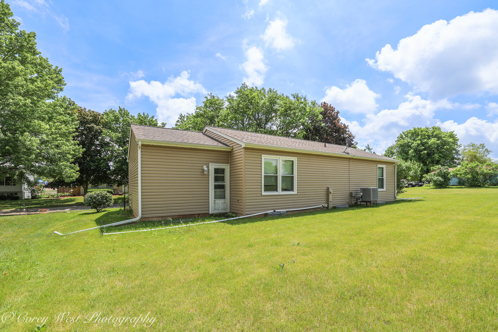 335 South Hadsall Street Genoa, IL 60135 - Photo 17 of 23 front view of house with yard and trees in the background